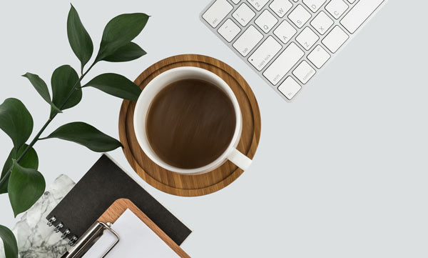 Desk, coffee and keyboard in therapeutic office