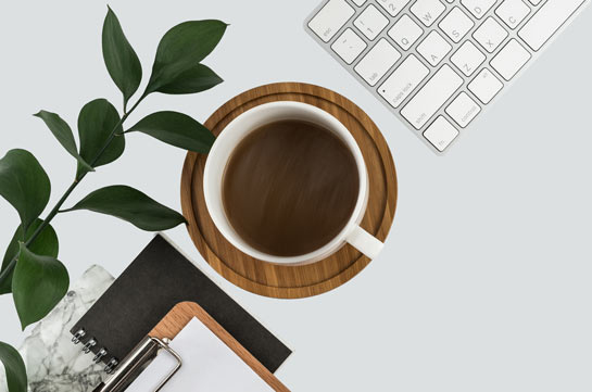 Desk with coffee and a keyboard